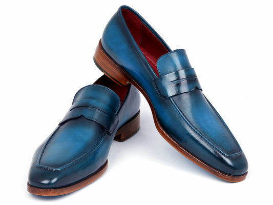 The Paul Parkman Penny Loafer in Blue & Turquoise Calfskin, model 10TQ84, features a hand-painted blue leather design complemented by brown soles and is showcased against a white backdrop.