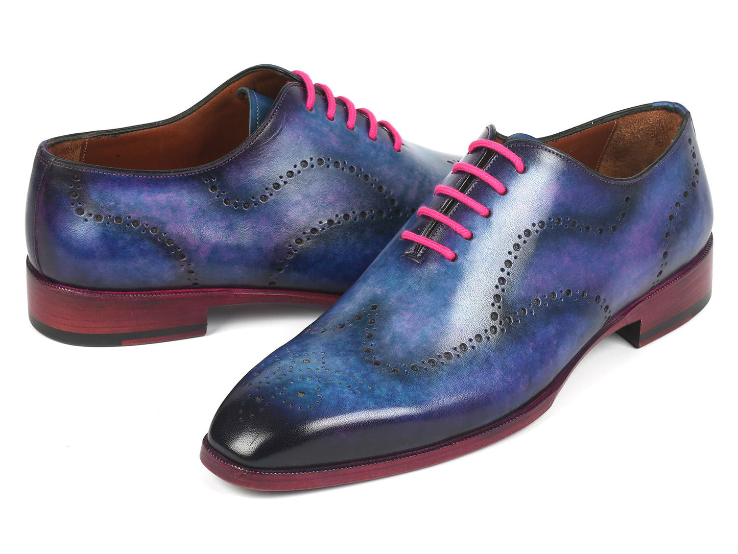 A pair of Paul Parkman's Men's Wingtip Oxfords in Parliament Blue leather, adorned with pink laces and featuring wingtip perforated decoration, is displayed against a white background.