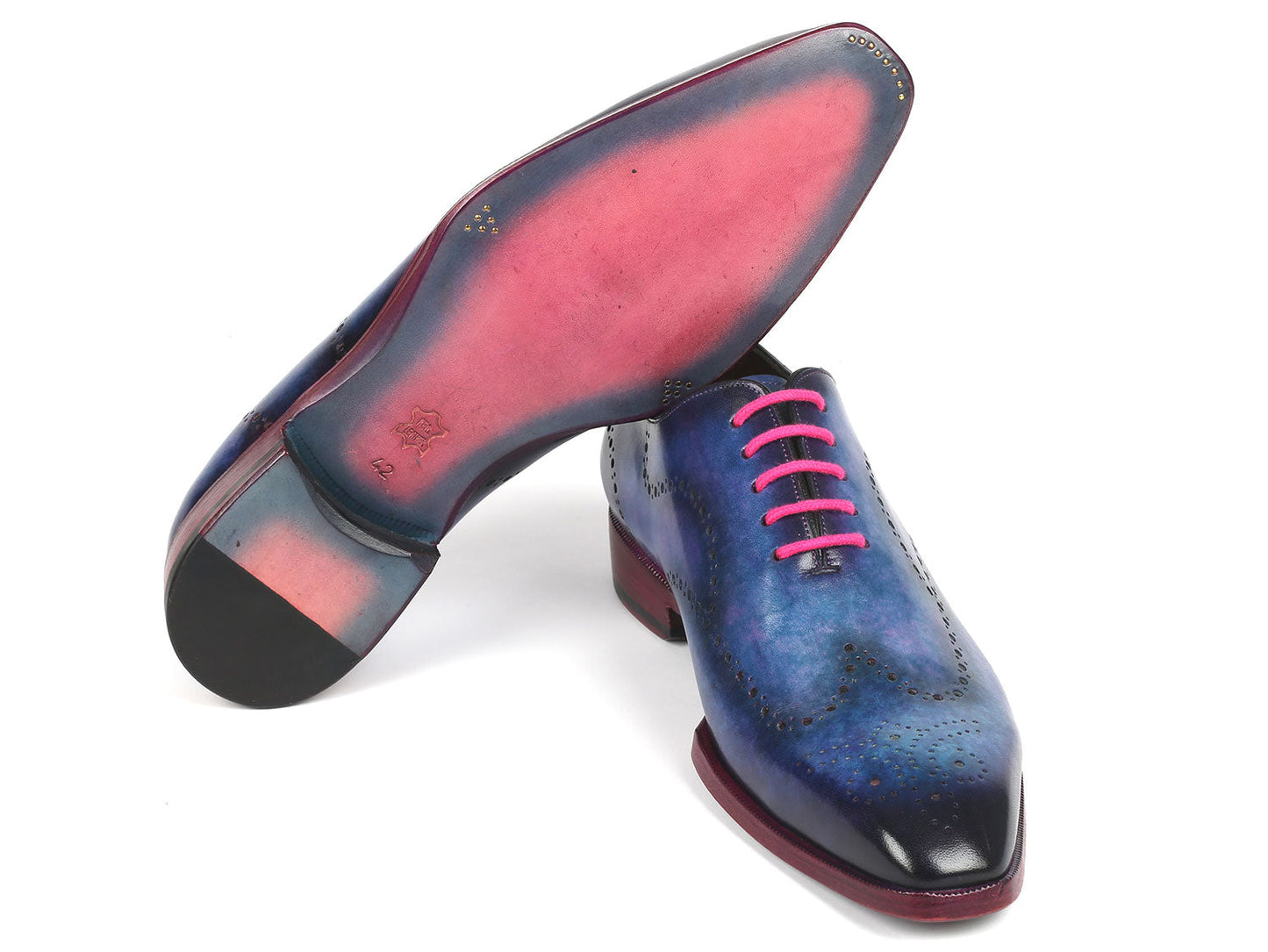 A pair of Paul Parkman's Men's Wingtip Oxfords in Parliament Blue leather, adorned with pink laces and featuring wingtip perforated decoration, is displayed against a white background.