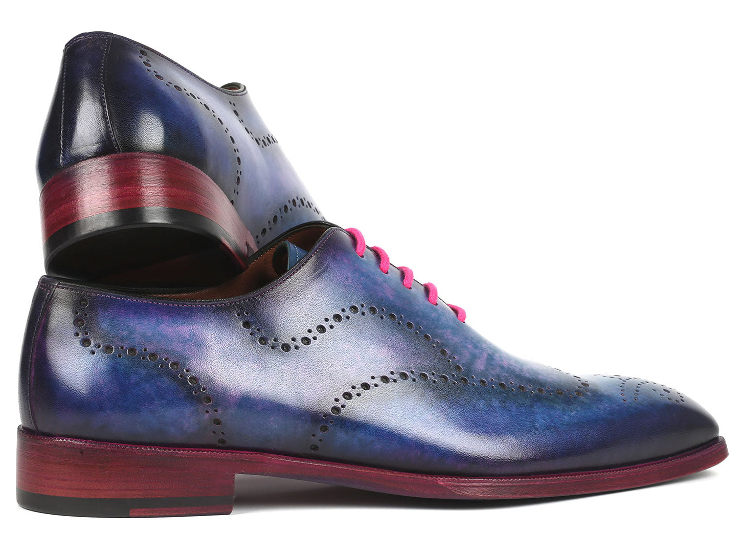 A pair of Paul Parkman's Men's Wingtip Oxfords in Parliament Blue leather, adorned with pink laces and featuring wingtip perforated decoration, is displayed against a white background.