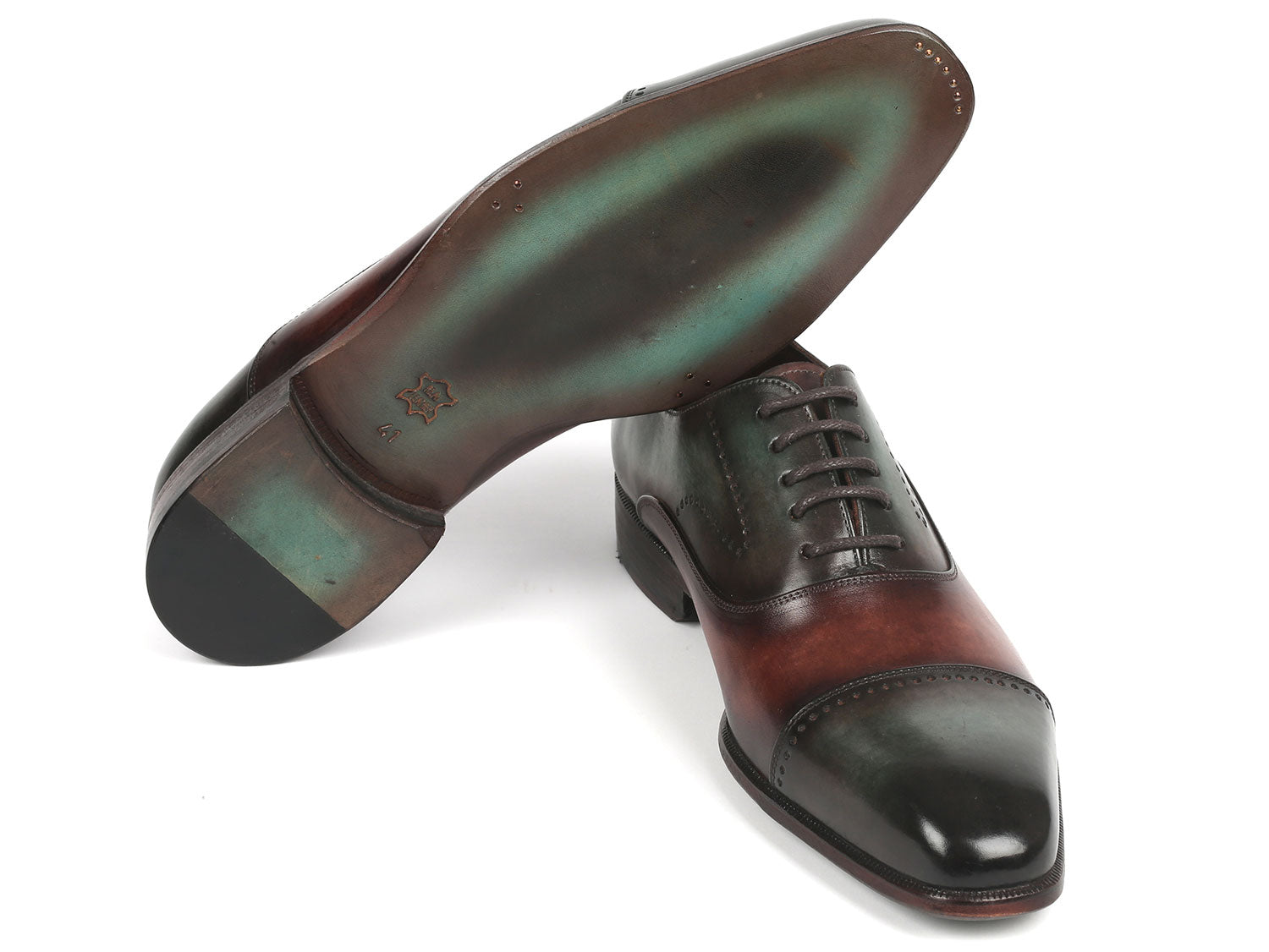 The Paul Parkman Men's Cap Toe Oxfords in Green & Brown 314-GRNBRW are handcrafted shoes featuring perforated details and lace-up closures, displayed overlapped.