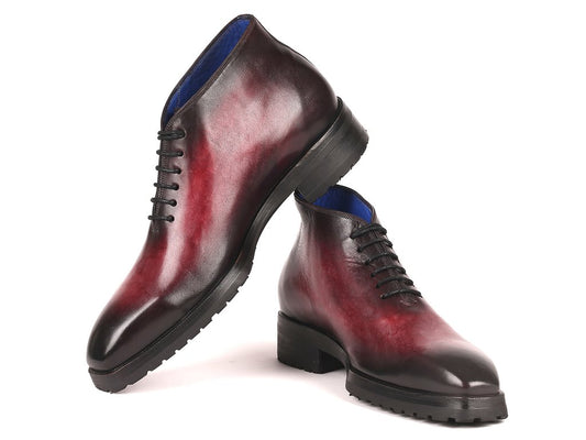 A pair of Paul Parkman Ankle Boots in a Bordeaux burnished finish, featuring a shiny, red and black gradient design, lace-up style with hand-painted leather, and black chunky soles, arranged artistically on a white background.
