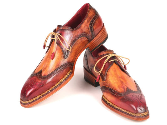 A pair of Red & Camel Norwegian Welted Wingtip Derby Shoes by Paul Parkman, featuring intricate stitching, beige laces, and a hand-painted leather design.