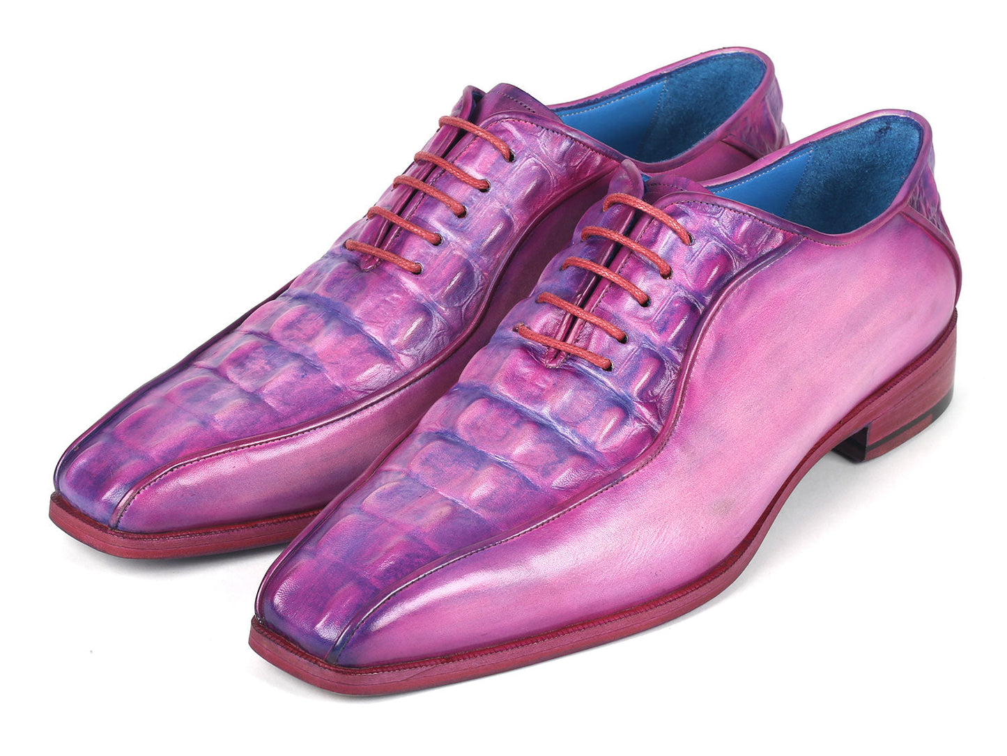 Introducing the Paul Parkman Purple Croco Textured Leather Bicycle Toe Oxfords - 94-277: a pair of handmade shoes crafted from shiny, lizard skin leather in a striking purple hue. Designed with a bicycle toe, these luxurious oxfords feature intricate blue lining and vibrant pink laces, elegantly displayed against a clean, white background.