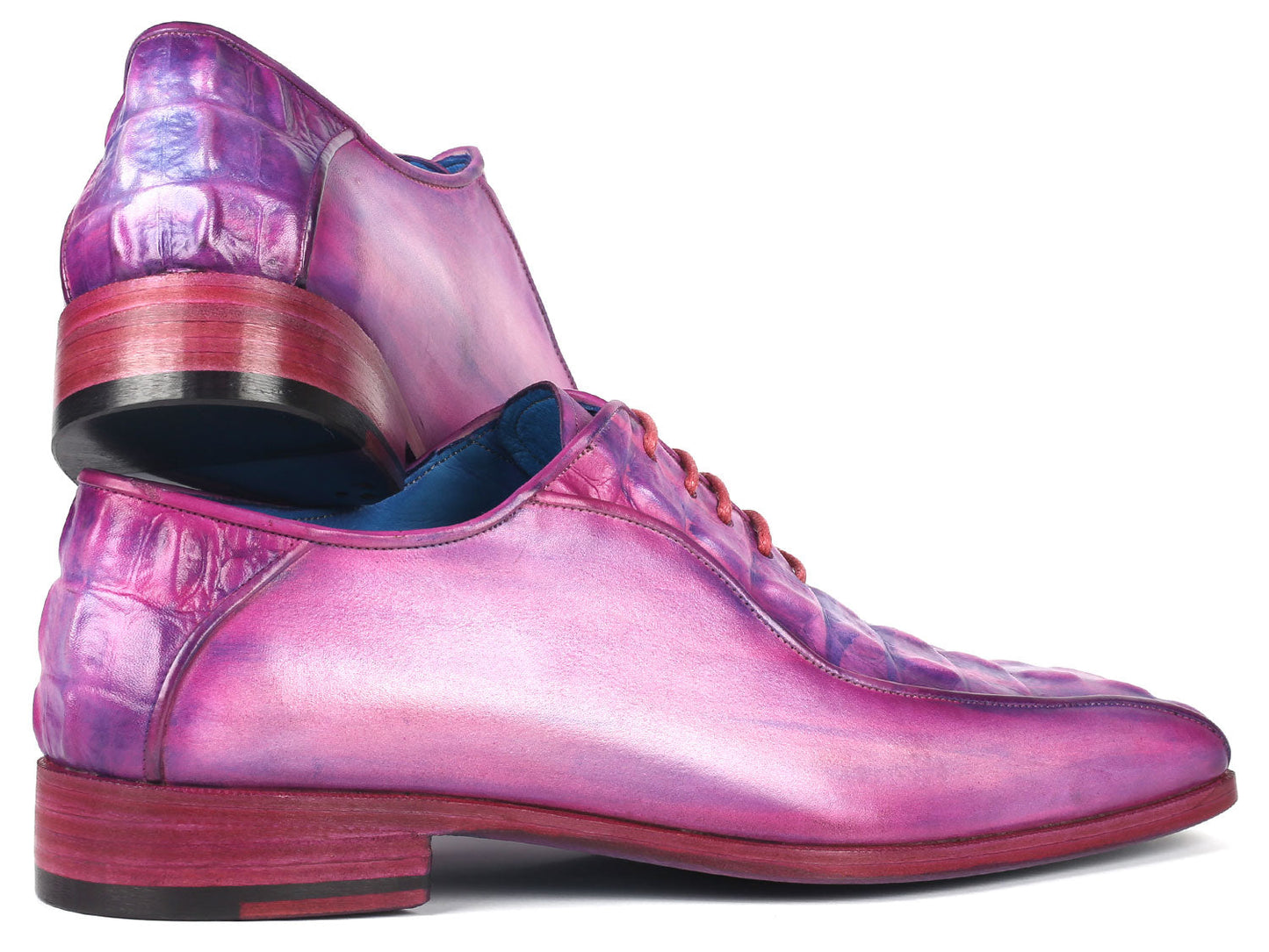 Introducing the Paul Parkman Purple Croco Textured Leather Bicycle Toe Oxfords - 94-277: a pair of handmade shoes crafted from shiny, lizard skin leather in a striking purple hue. Designed with a bicycle toe, these luxurious oxfords feature intricate blue lining and vibrant pink laces, elegantly displayed against a clean, white background.