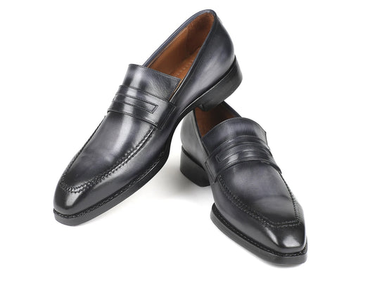A pair of Paul Parkman Gray Burnished Goodyear Welted Loafers featuring stitched detailing and a sleek finish, crafted from hand-painted calfskin leather, with one shoe elegantly placed atop the other.