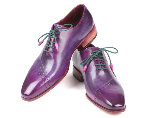 The Paul Parkman Opanka Construction Purple Hand-Painted Oxfords - OPK66KD are crafted with Opanka construction and feature green laces and brown soles. These stylish Oxfords, from the Paul Parkman brand, have perforated detailing on the toe caps and boast a unique design with hand-painted leather that enhances their sophisticated appeal.