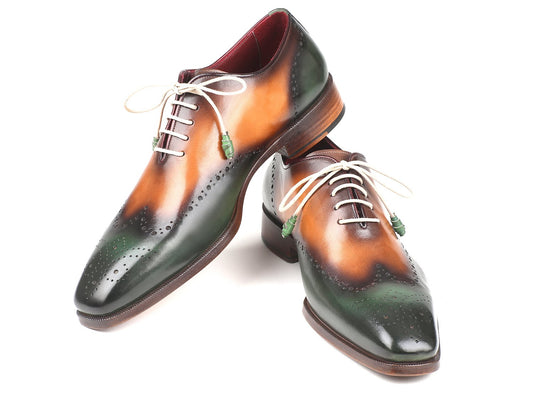 Paul Parkman presents the Green & Camel Wingtip Oxfords - 097GV22, a pair of handmade brogues crafted from hand-painted leather in green and brown, featuring white laces and intricate perforated detailing, displayed on a white background.