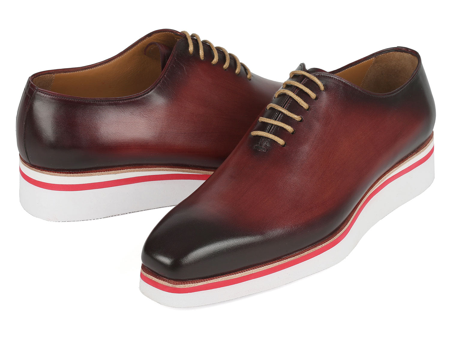 The Paul Parkman Smart Casual Wholecut Oxfords Bordeaux - 191-BRD are exquisite brown leather dress shoes, featuring unique hand-painted white and red striped soles and complemented by beige laces. These shoes are ideal for adding a touch of distinction to your smart casual collection.