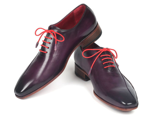 A pair of Paul Parkman Purple Leather Oxfords Side Hand-Sewn - 018-PRP, crafted from premium calfskin in a dark purple shade, featuring distinctive red laces and brown soles with Opanka construction.