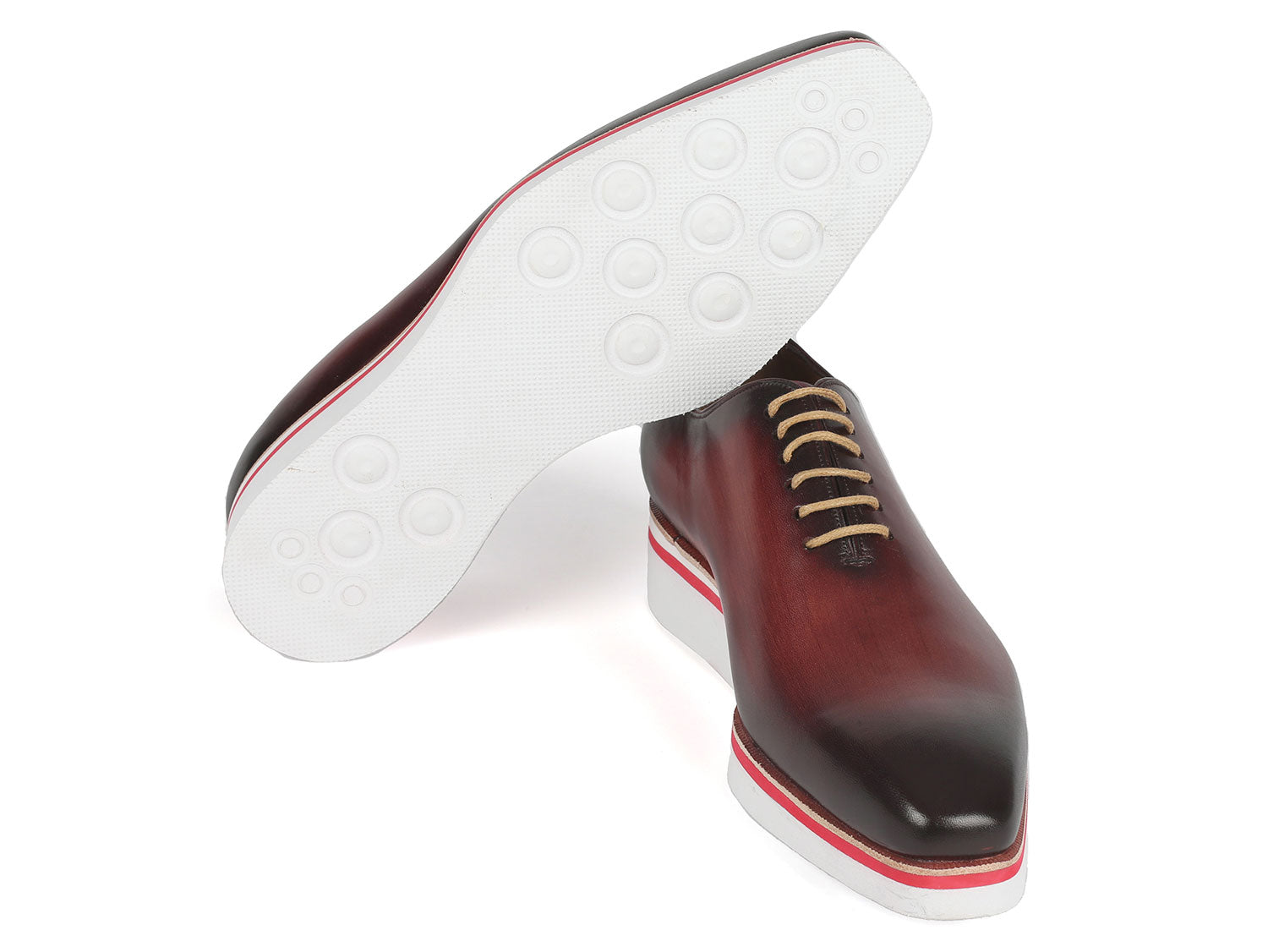 The Paul Parkman Smart Casual Wholecut Oxfords Bordeaux - 191-BRD are exquisite brown leather dress shoes, featuring unique hand-painted white and red striped soles and complemented by beige laces. These shoes are ideal for adding a touch of distinction to your smart casual collection.