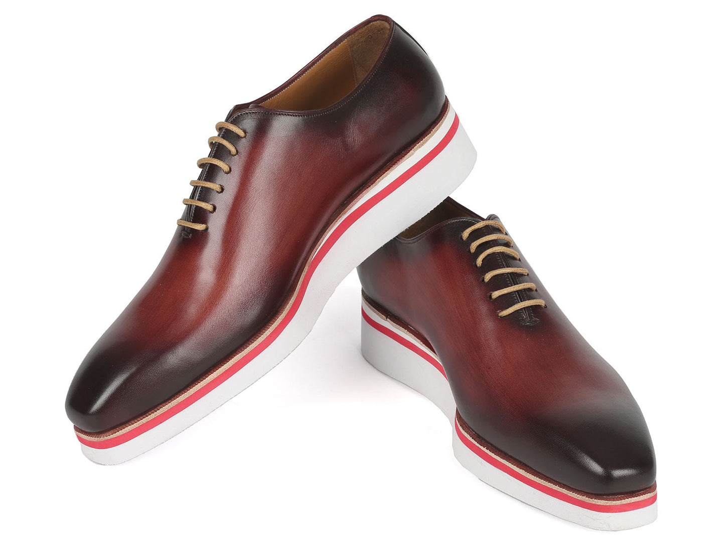 The Paul Parkman Smart Casual Wholecut Oxfords Bordeaux - 191-BRD are exquisite brown leather dress shoes, featuring unique hand-painted white and red striped soles and complemented by beige laces. These shoes are ideal for adding a touch of distinction to your smart casual collection.
