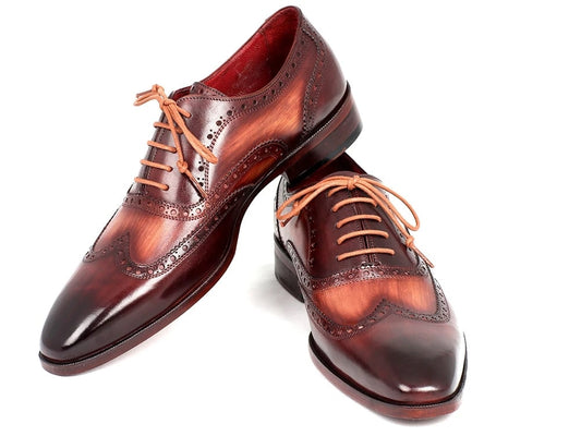 The Paul Parkman Two Tone Wingtip Oxfords - PP22TX54, elegant dress shoes by Paul Parkman, are crafted from hand-painted brown leather and feature intricate brogue detailing along with tan laces.