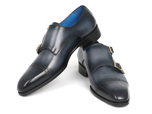 A pair of navy Paul Parkman Captoe Double Monkstraps, expertly crafted with hand-painted leather and featuring a polished finish and decorative stitching, displayed against a white background.