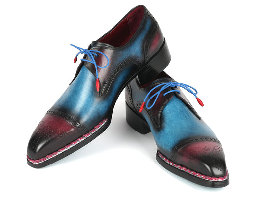 Introducing the Paul Parkman Norwegian Welted Cap Toe Derby Shoes in blue and purple leather, model 8508-PBL. These exquisite dress shoes feature decorative stitching, red accents, and blue laces, highlighting the brand's renowned hand-painted leather craftsmanship with a polished finish.