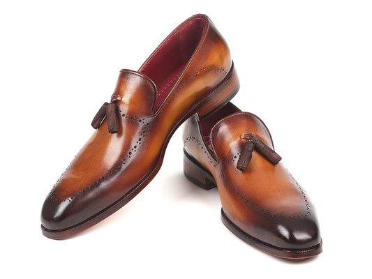 The Paul Parkman Tassel Loafer Brown - 66T81-BRW showcases hand-painted finesse and decorative perforations arranged in a crossed position on a pristine white background.
