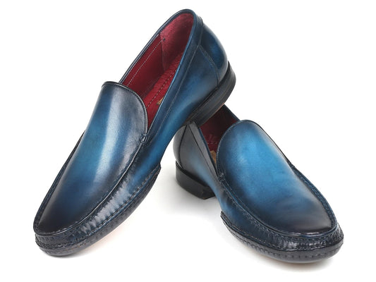 A pair of Paul Parkman Hand-Sewn Moccasins Blue (MC649-BLU) with a red inner lining, showcased against a white background.
