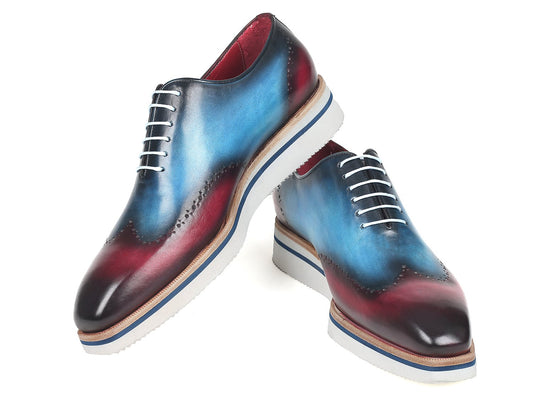 The Paul Parkman Smart Casual Wingtip Oxfords, model 187-BLU-PRP, feature a unique blue and purple gradient leather design with white laces and soles. These hand-painted shoes are ideal for anyone who values bespoke style.