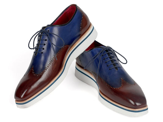 Paul Parkman introduces the Smart Casual Wingtip Oxfords Brown & Blue - 187-BRW-BLU, which feature a stylish combination of blue and brown hand-painted leather, elegant wingtip perforations, white soles, and black laces for a sophisticated touch.