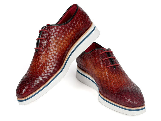 The Paul Parkman Brown Woven Leather Smart Casual Shoes (182-RDH-BRW) showcase a textured, woven leather upper complemented by white platform soles and blue accents. One shoe is elegantly positioned standing on its heel, emphasizing the unique design of this made-to-order product from Paul Parkman.