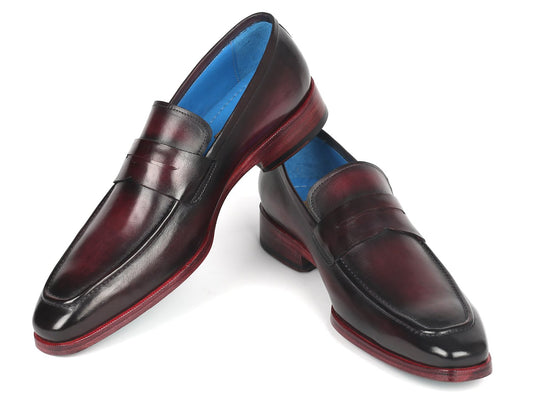 Introducing the Paul Parkman Purple Burnished Penny Loafers - 10PR23, a stunning pair of made-to-order shoes that display exquisite craftsmanship. These handcrafted loafers feature unique details like red soles and a blue interior lining, embodying luxury and sophistication.