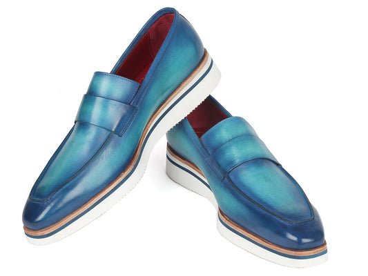 The Paul Parkman Smart Casual Loafers Blue - 183-BLU-TRQ display a blend of blue hand-painted leather with white soles and brown accents, all set against a white backdrop.