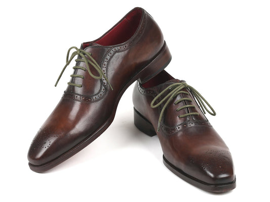 A pair of Paul Parkman Brown Medallion Toe Oxfords - FS78BW, crafted by Paul Parkman, features exquisite hand-painted leather with decorative perforations and green laces.