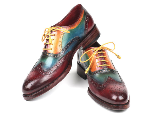 The Paul Parkman Wingtip Oxfords Goodyear Welted Multicolor - 027-MIX are vibrant leather brogues with yellow laces, showcasing a blend of green, blue, yellow, and maroon colors. These handmade shoes feature Goodyear welted construction for enhanced durability and style.