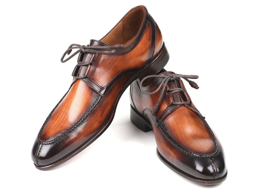 Introducing the Paul Parkman Ghillie Lacing Brown Burnished Dress Shoes - GU567BRW, a pair of exquisite dress shoes crafted by Paul Parkman. Featuring intricate ghillie lacing, a polished finish, and detailed stitching, these hand-painted leather shoes are beautifully displayed against a white background, showcasing exceptional craftsmanship.