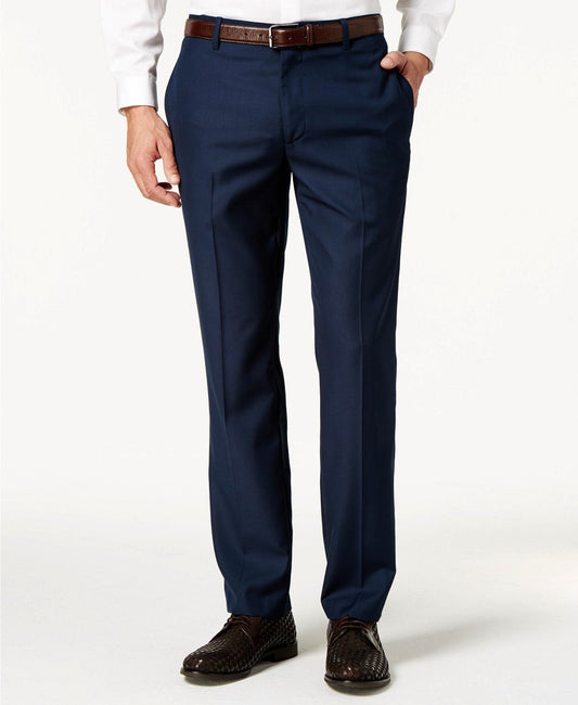 A man in a white shirt is styled with Vinci Suits' wrinkle-resistant Slim Fit Flat Front Pre-Hemmed Dress Pants in Navy, complemented by a brown leather belt and matching shoes.