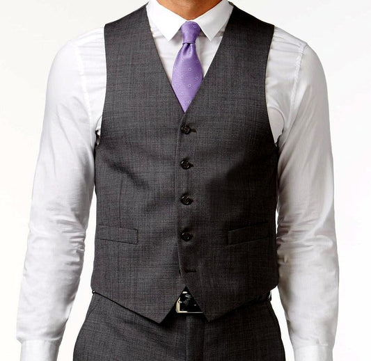A man wears the Vinci Suits Slim Fit Single Breasted 5 Button Vest in charcoal gray (OV-900), paired with a white shirt and a purple tie.