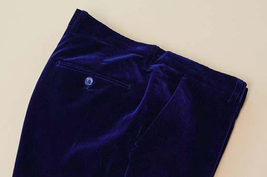 Captured against a light beige background, the Inserch Velvet Pants P502-13 Royal Blue feature a dark blue velvet poly nylon blend with a back pocket enhanced by a button. These stylish trousers by Inserch boast a modern fit that elevates their sleek silhouette.