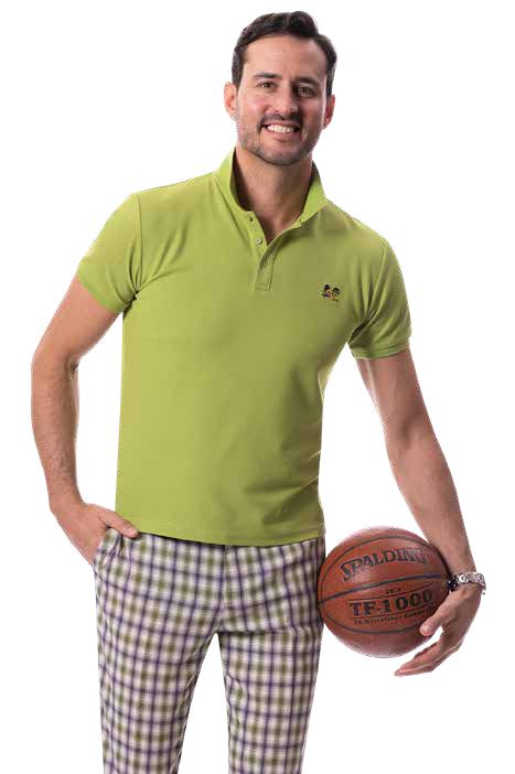 A man wearing a green polo shirt and EJ Samuel Purple Plaid Pants PL131, holding a basketball, smiles at the camera against a white background.