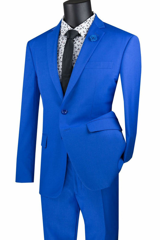 Displayed on a mannequin, the Vinci Suits Slim Fit 2 Piece Royal Suit SC900-12 captures modern elegance with a sharp blue blazer and pants, paired with a floral white shirt and black tie. This wrinkle-resistant ensemble is the essence of sophisticated style for any occasion.