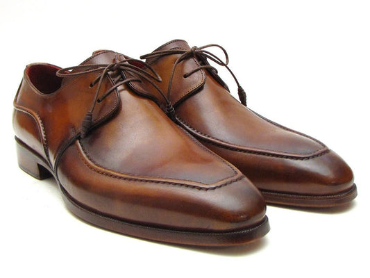 A pair of Paul Parkman Brown Derby Dress Shoes - SU12LF, exquisitely handpainted and featuring a leather sole with laces, displayed elegantly on a plain background.