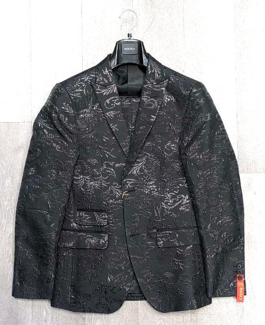 The Inserch Floral Jacquard Suit SU800-01 Black, by Inserch, is elegantly displayed on a wooden wall, featuring a subtle floral pattern and printed lining that highlights its slim fit.