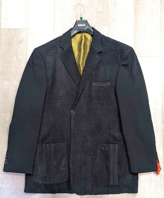 A sophisticated black Inserch Blazer BL506-01, available exclusively in size 3XL, with a notched lapel and vibrant yellow lining, hangs elegantly on a hanger. It features two front pockets and a chest pocket.