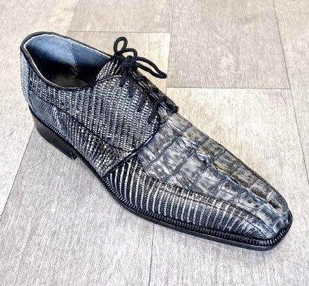 The Romano by Los Altos, a black and gray textured dress shoe crafted with genuine croc, featuring laces, is elegantly displayed on a light wood floor.