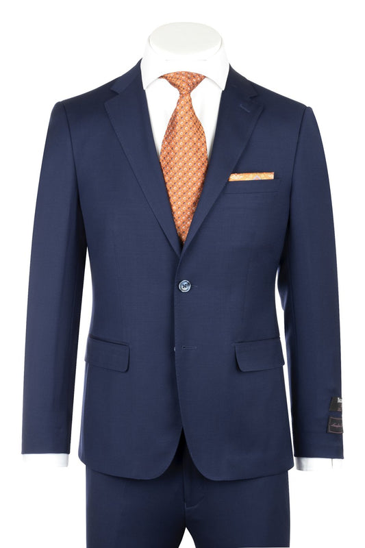 A Porto French Blue, Slim Fit, Pure Wool Suit by Tiglio Luxe paired with a white shirt and an orange patterned tie showcases the craftsmanship of master tailors and fine Italian fabrics. An orange pocket square enhances the outfit with a sophisticated European flair.