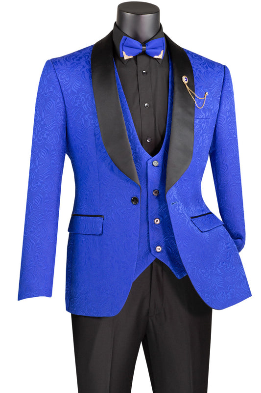 The Vinci Suits Slim Fit 3 Piece Single Button Jacquard Fabric Tuxedo (Royal) TVSJ-1 flaunts a blue patterned design with black lapels, sleek blazer, and gold-buttoned waistcoat. Paired with a black shirt, blue bow tie, and gold chain, it's elegantly showcased on a mannequin.