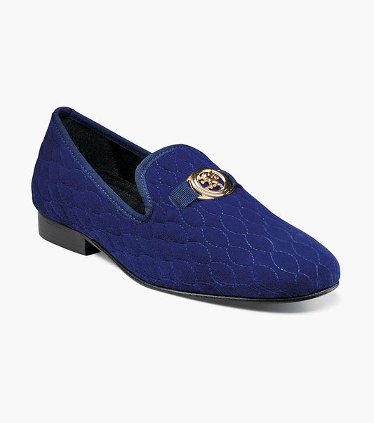 The Stacy Adams Valet Slip On Bit Loafer (25166-400) features a blue quilted upper, low black heel, memory foam insole, and a gold circular emblem on the front.