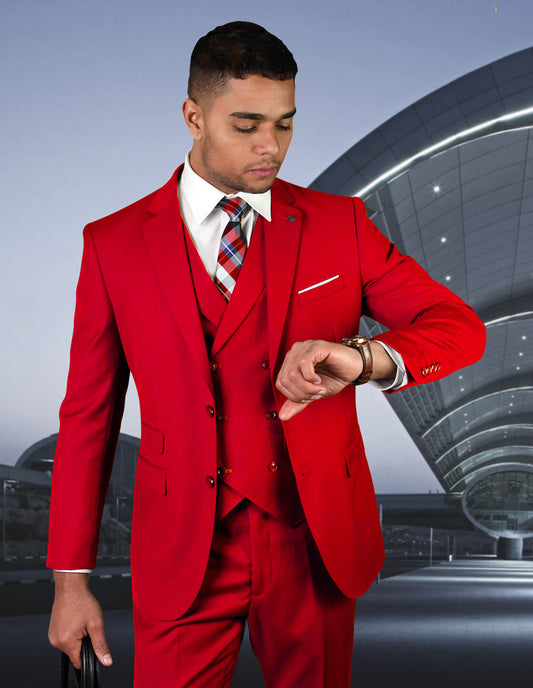 A man wearing the ZARGALA-RED from Statement Clothing, featuring a double-breasted vest, checks his watch in front of a modern, curved architectural structure.