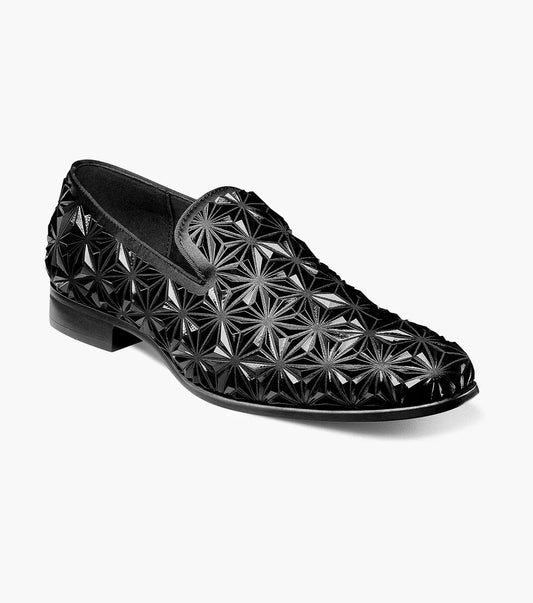 The Stacy Adams Sequence Plain Toe Slip On (25535-001) is a black dress shoe with a glossy geometric star pattern, memory foam insole, and low heel, shown against a plain white background.