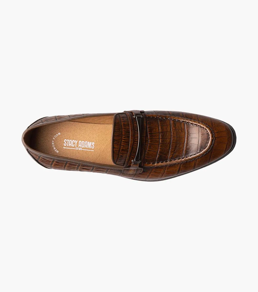 The STACY ADAMS Ferdinand Moc Toe Bit Slip On in Cognac features croco print leather, a decorative metal bit, and a cushioned memory foam footbed, displayed on a white background.
