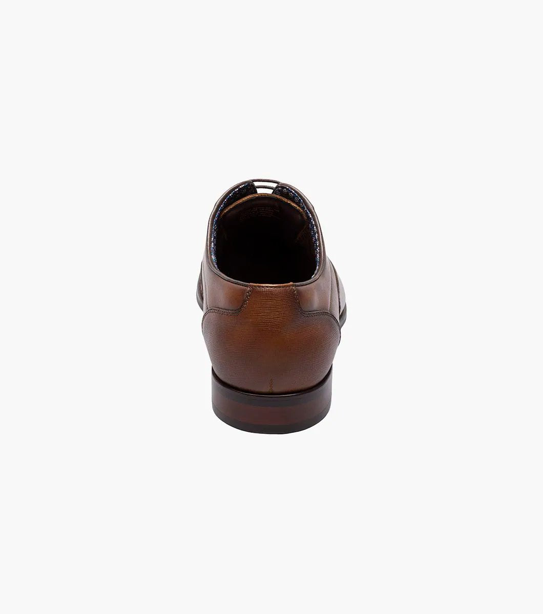 The STACY ADAMS Kallum Cap Toe Oxford in Cognac (25568-221) is a brown men's dress shoe with a cushioned footbed and dark laces, shown on a white background.