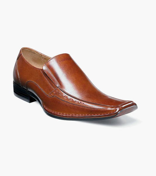 The Stacy Adams Templin Bike Toe Loafer in cognac (24507-221) features brown genuine leather, a pointed toe, low black heel, and decorative stitching—a classic slip-on dress shoe by STACY ADAMS.