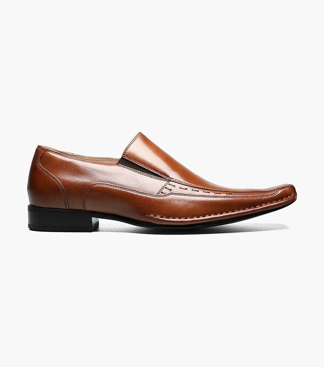 The Stacy Adams Templin Bike Toe Loafer in cognac (24507-221) features brown genuine leather, a pointed toe, low black heel, and decorative stitching—a classic slip-on dress shoe by STACY ADAMS.