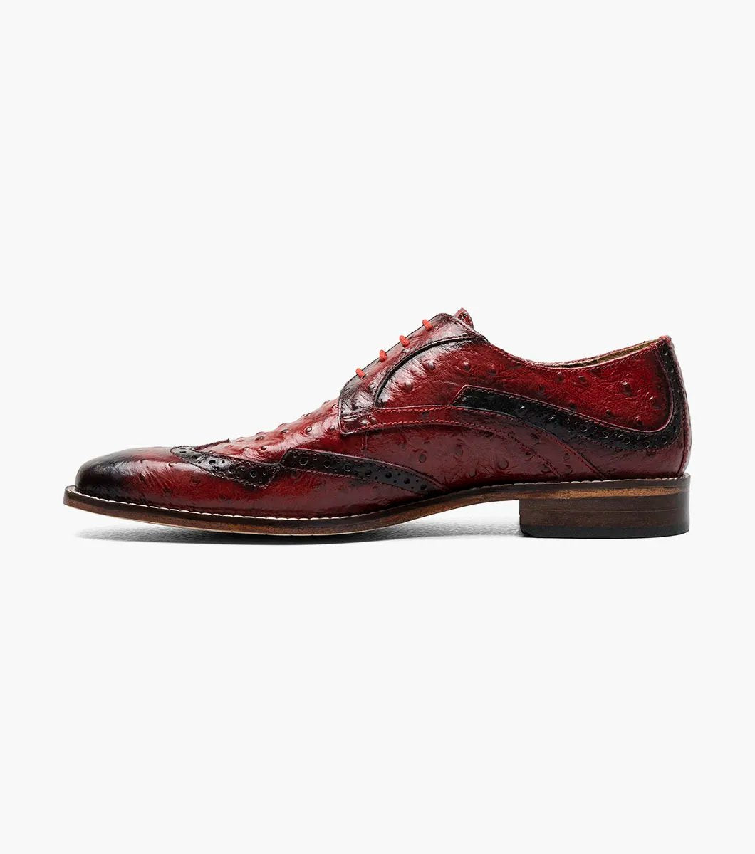 The Stacy Adams GENNARO Wingtip Oxford in red (model 25537-600) showcases an exquisite design. With its genuine leather outsole and elegant brogue features, this sophisticated dress shoe offers a textured surface with decorative perforations, a lace-up closure, and a low heel for those who appreciate timeless style.