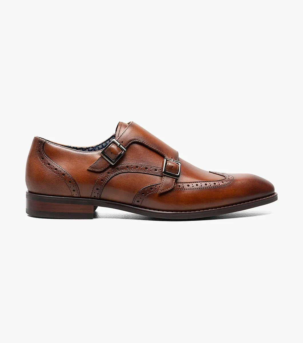 The STACY ADAMS Karson Wingtip Double Monk Strap dress shoe in Cognac features decorative perforations and a low heel, shown on a white background. Model: 25570-221.
