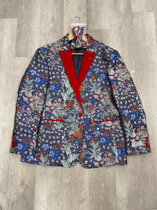 The Inserch Kent & Park Fashion Blazer (FINAL SALE, SIZE 46 ONLY) features a floral pattern with red lapel and red accents on pockets and cuffs, displayed on a hanger over a wooden floor. No returns or exchanges.